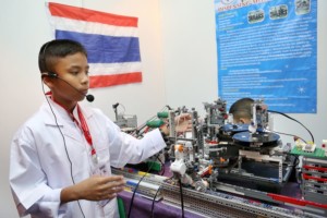 A student operating a complicated looking machine in a presentation